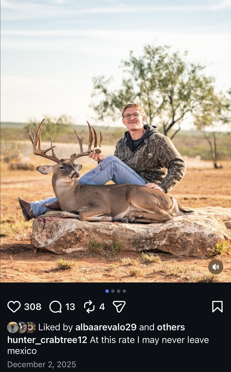 Hunter posing with a whitetail buck