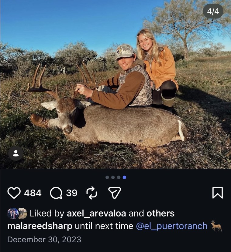 Hunter posing with a mule deer buck